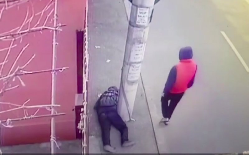 Un bărbat rănit, prăbuşit inconştient pe trotuar, a fost jefuit de un tânăr. Momentul a fost filmat